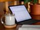 ipad pro on desk with notebook and tea